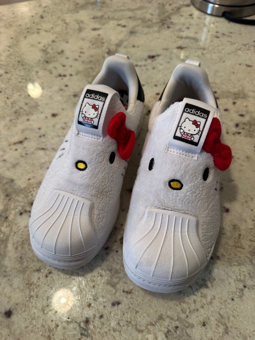 adidas Kids White Hello Kitty Slip-On Sneakers with Red Bow Accent